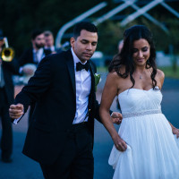 bride and groom dancing at their wedding with prohibition era jazz band dancing behind